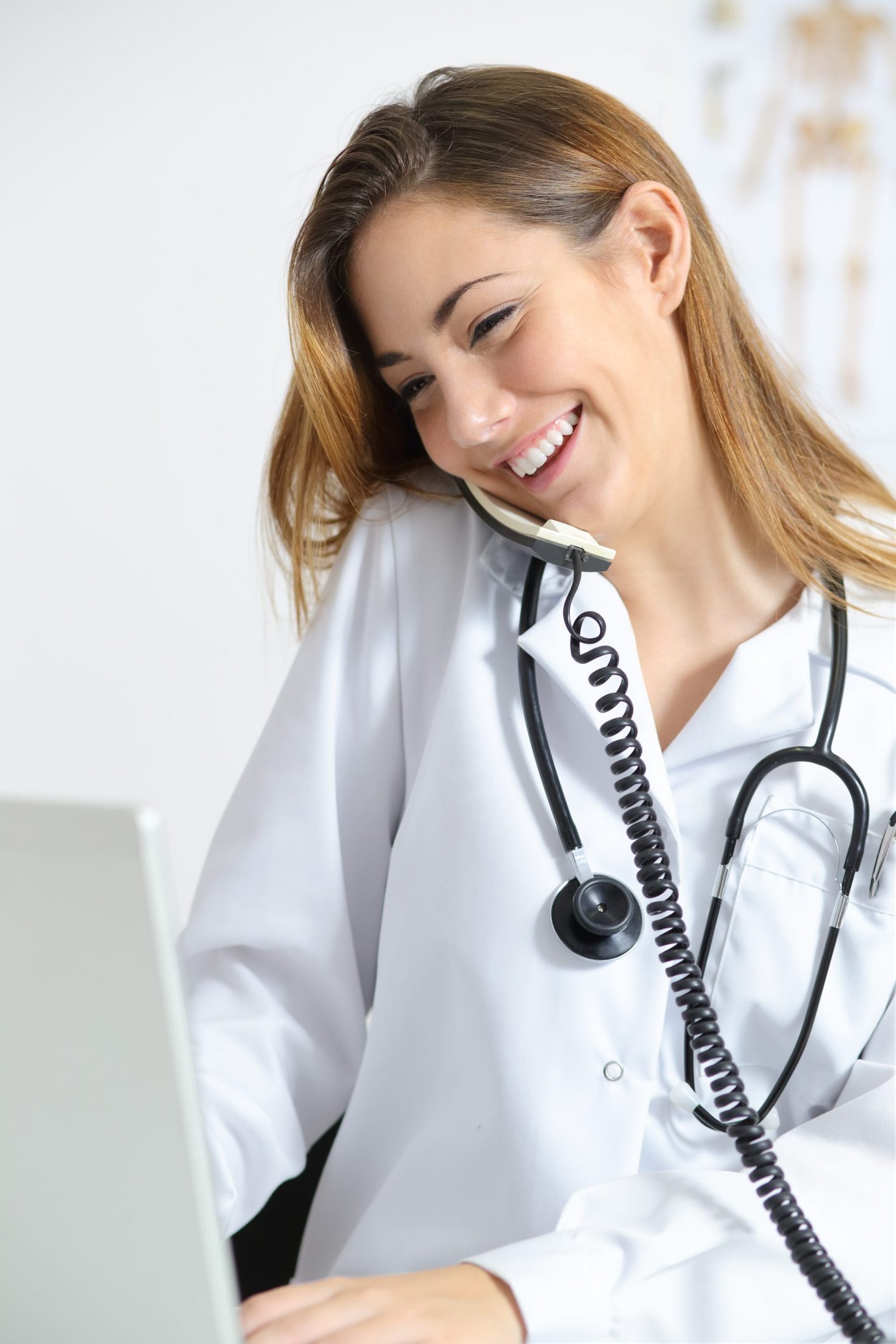 Beautiful doctor in a consultation talking on the phone Cardiolex